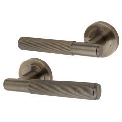 Altro Antique Brass Lines Door Handles on Round Rose - Nova Range