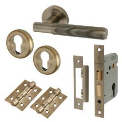 Altro Antique Brass Reeded Euro Lock Door Handles on Rose Pack - Lily Range