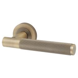 Jedo Antique Brass Fire Rated Knurled Door Handles on Round Rose - Bari Range