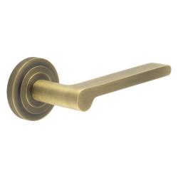 Burlington by Frelan Antique Brass Fire Rated Door Handles on Round Stepped Rose - Fitzrovia Range